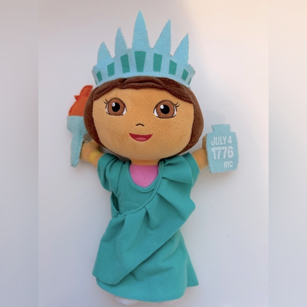 Dora the Explorer plush doll dressed as the Statue of Liberty.